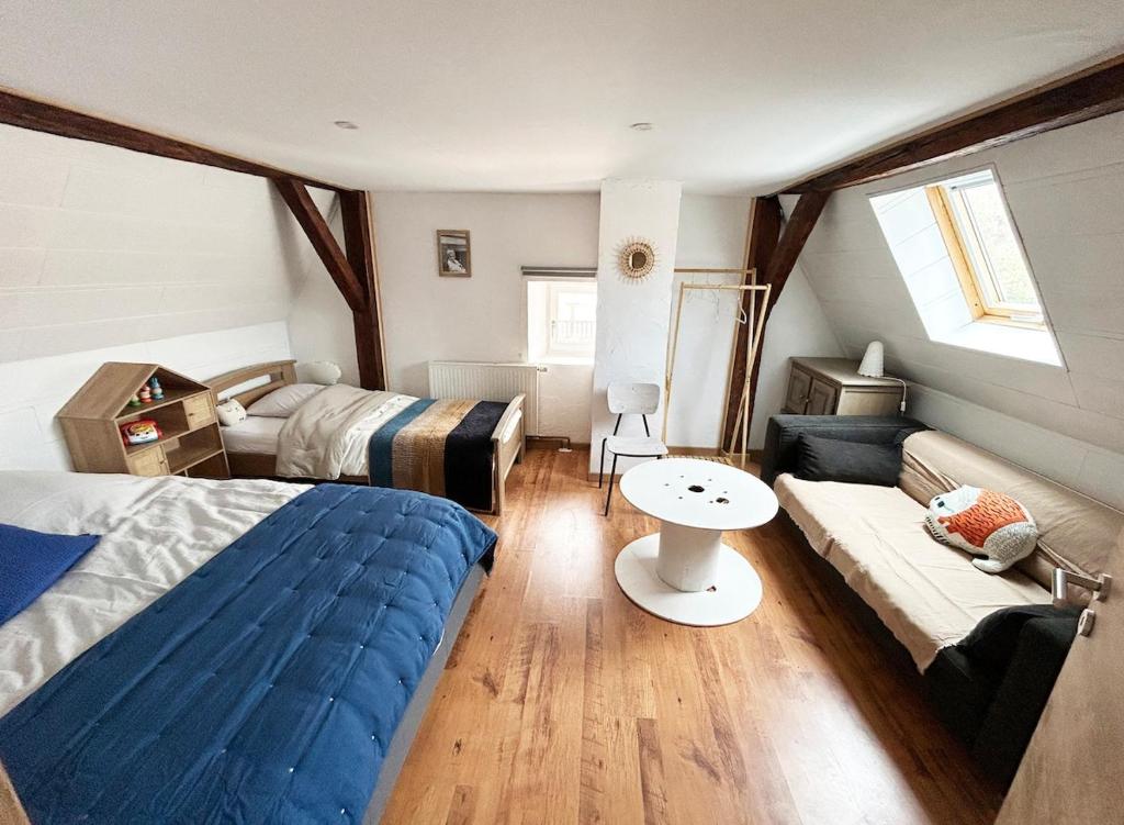 a bedroom with two beds and a couch at Maison familiale alsacienne au centre ville in Obernai