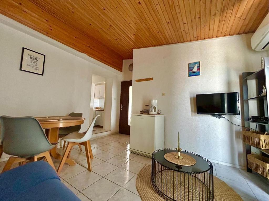 a living room with a blue couch and a table at Apartments Kety in Jezera