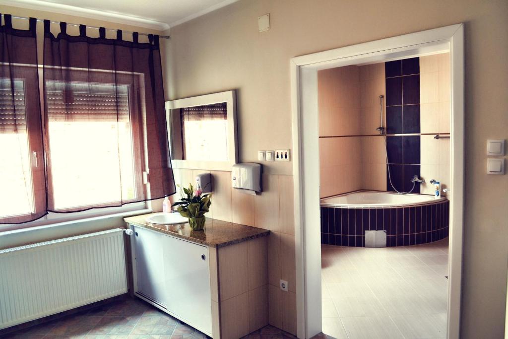 a bathroom with a tub and a sink and a toilet at Hostel Art Gradiska in Bosanska Gradiška