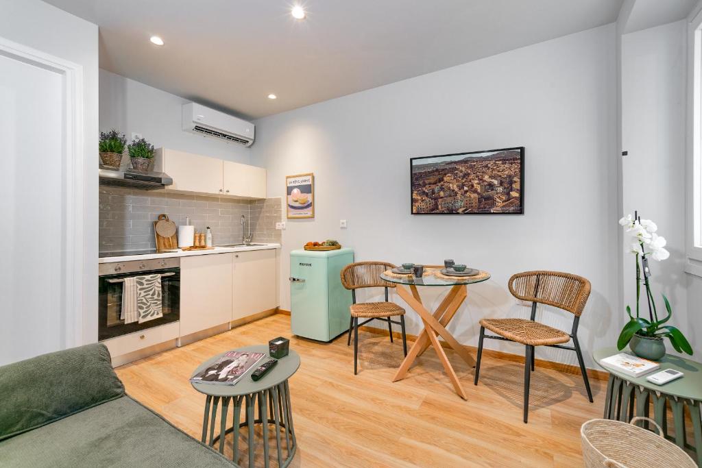 uma sala de estar com mesa e cadeiras e uma cozinha em Porta Rem Studio by Konnect, Old Corfu Town em Corfu Town