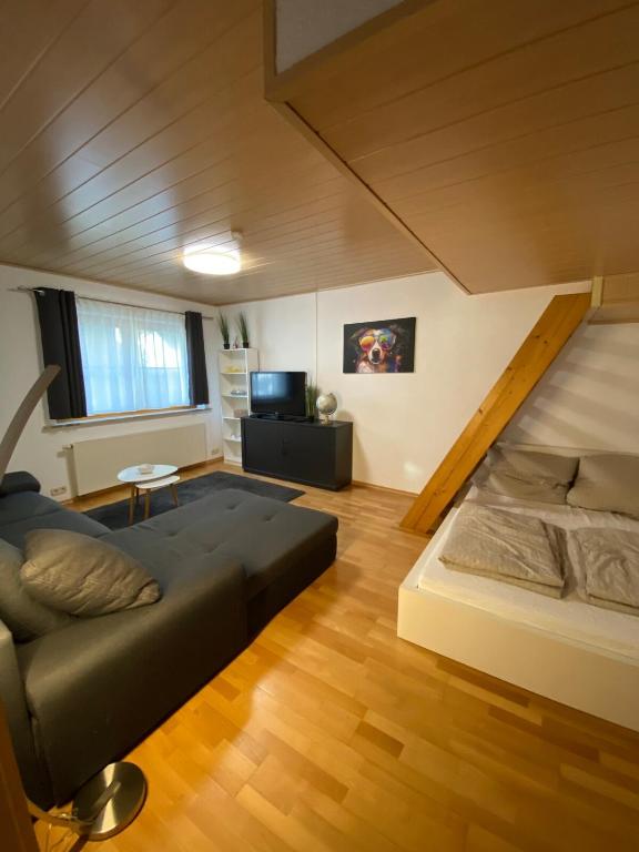a living room with a couch and a loft at Ferienwohnung am Möhntal in Heidenheim an der Brenz