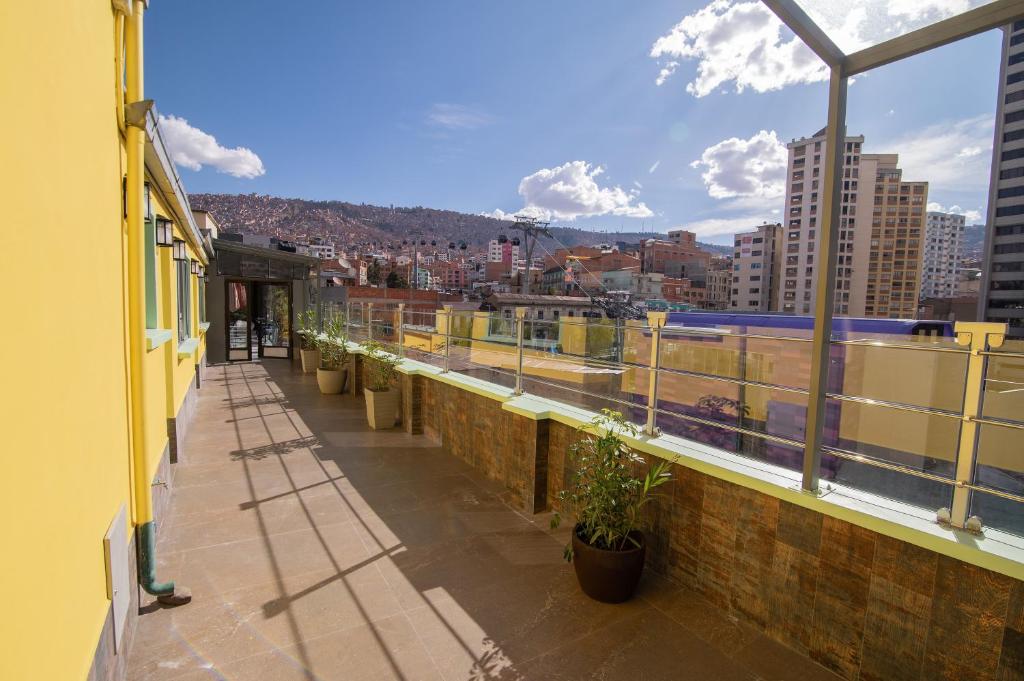 a balcony with potted plants and a view of a city at Kawsay Apart in La Paz