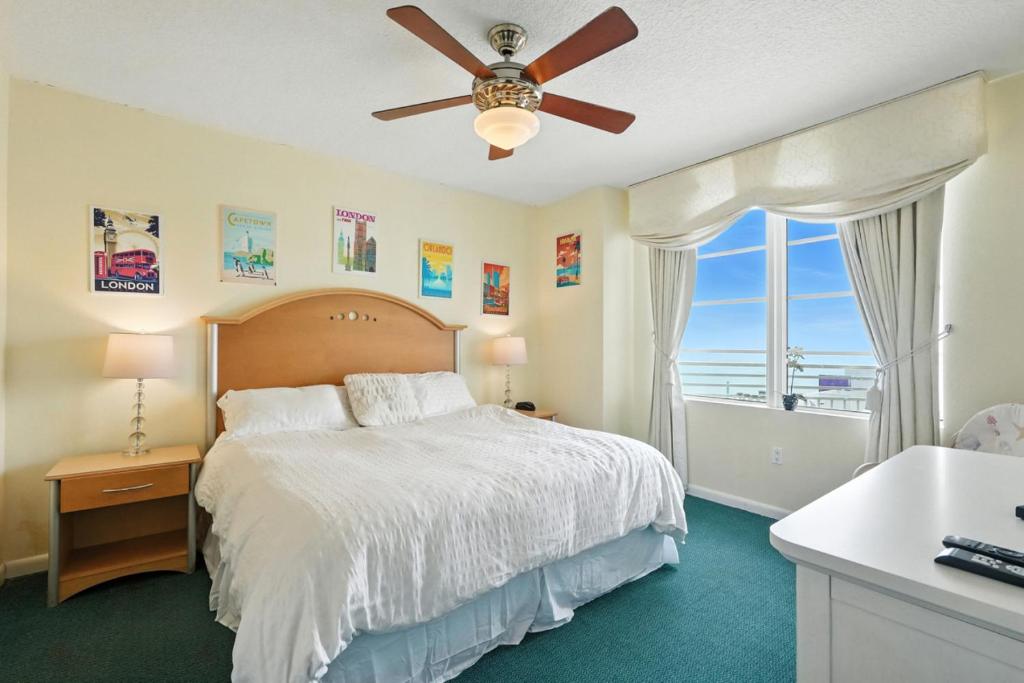a bedroom with a bed and a ceiling fan at *New Listing* Breathtaking 2BR condo with 2 Private Oceanview Balconys at Wyndham Ocean Walk Resort in Daytona Beach
