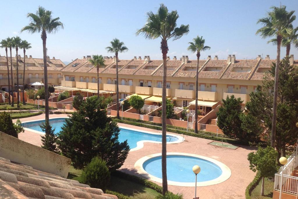 a resort with a swimming pool and palm trees at Valencia Flat Rental Perellonet in Valencia