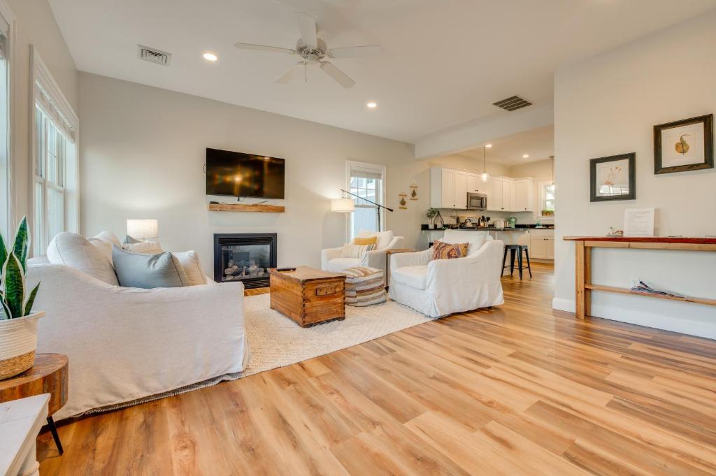 a living room with white furniture and a fireplace at Stylish Arundel Cottage, 6 Mi to Dock Square! in Arundel