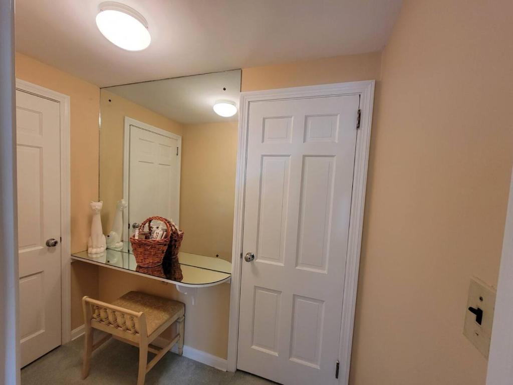 a bathroom with a mirror and a white door at Your Home Away from Home Sleeps 12 Fully Equipped in Youngstown