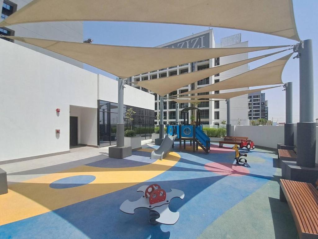 a play area with a playground with a canopy at Azizi Riviera 61 - Serene Studio in Meydan in Dubai