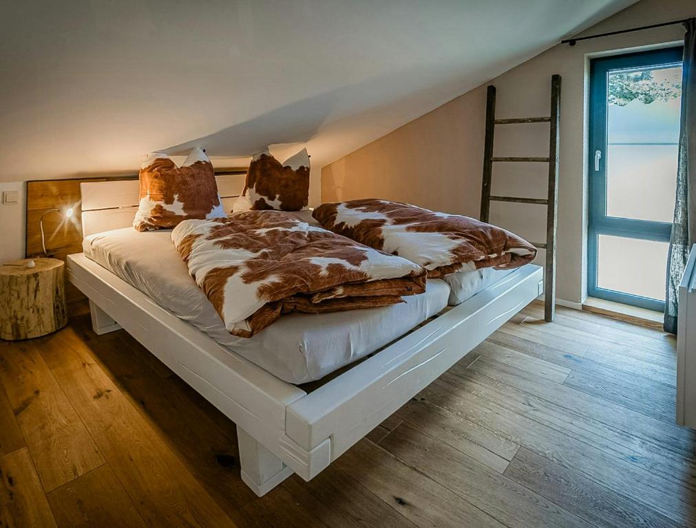 a bedroom with a large bed with a ladder at Modern Chalet With Sauna Near Thuringian Forest in Zella-Mehlis
