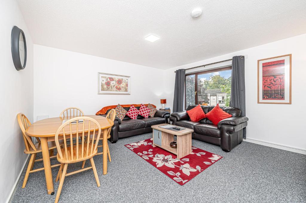 a living room with a couch and a table at City Centre Apartment in Dunfermline