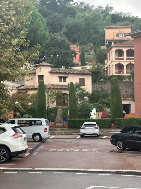 a parking lot with cars parked in front of a building at Villa la Tourelle in Théoule-sur-Mer