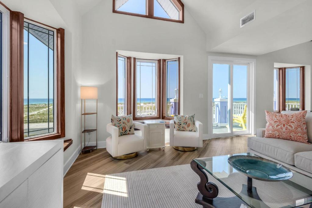 a living room with a view of the ocean at The Gulfview Grandeur in Pensacola Beach