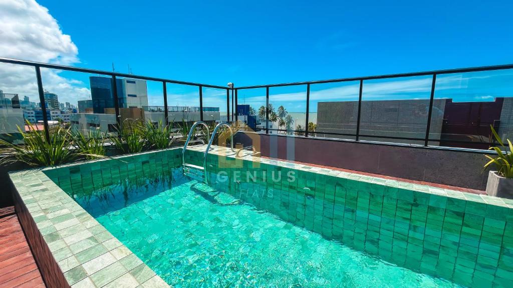 a swimming pool on the roof of a building at Áurea Bauten Cabo Branco Genius Flats in João Pessoa