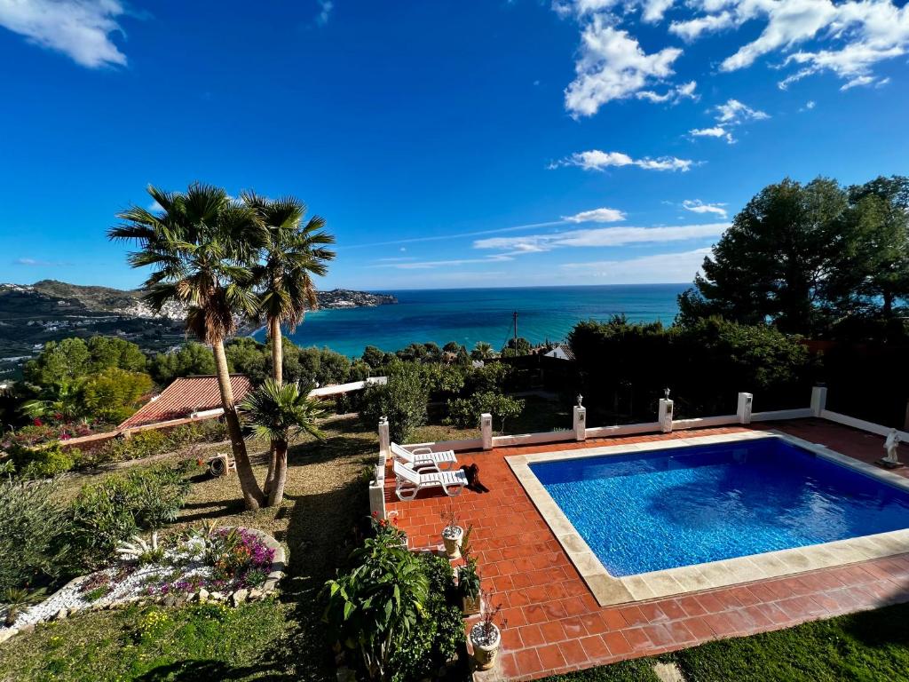 a villa with a swimming pool and a view of the ocean at Villa Marietta, private pool villa with sea views and terrace, perfect for families and remote stays in Almuñécar