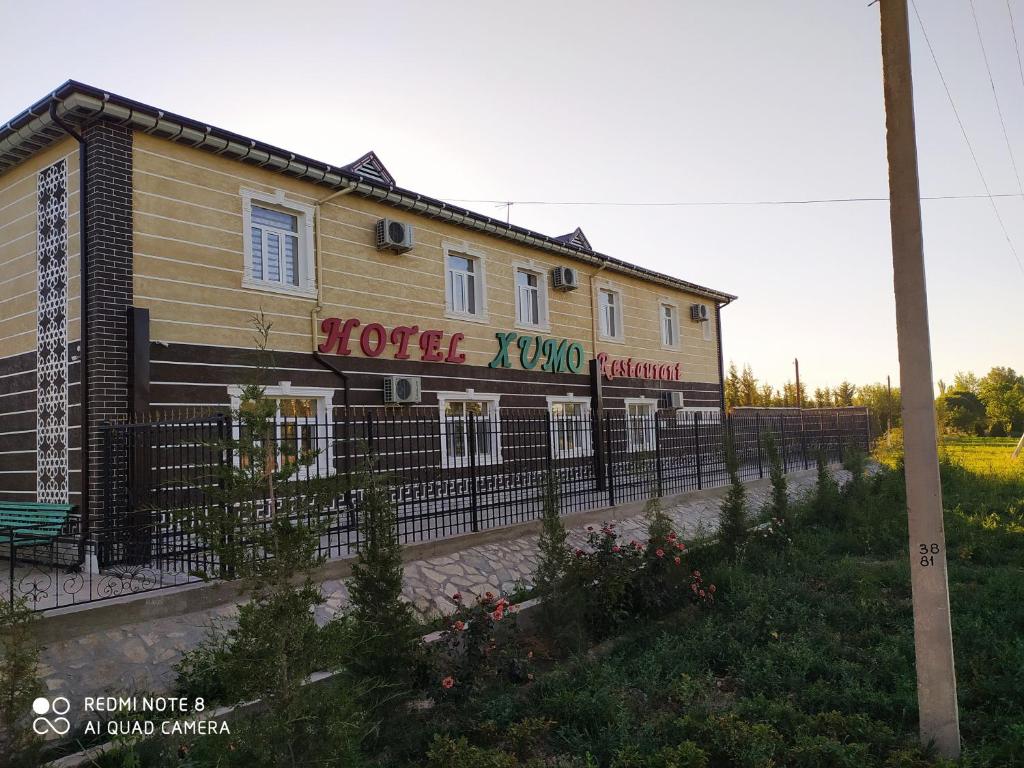 a building with a fence in front of it at Humo Hotel and Restaurant in Bŭston