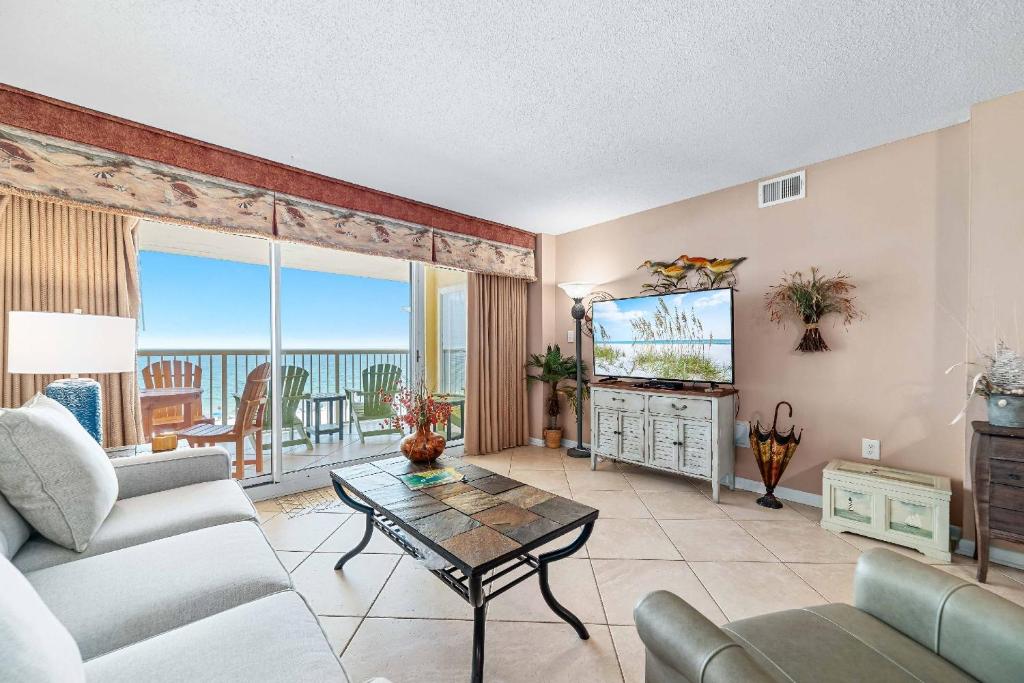 a living room with a couch and a tv at Driftwood Towers 5F in Gulf Shores