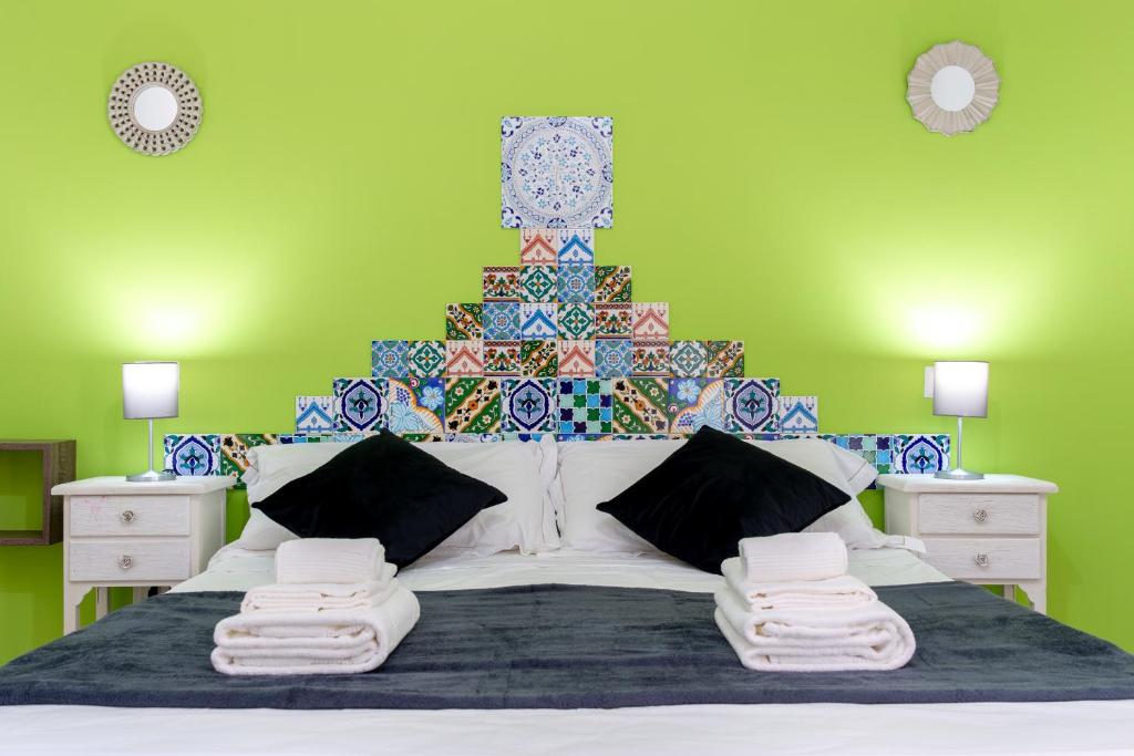 a bed with a christmas tree on top of it at Sterlizia Rooms in Gallipoli