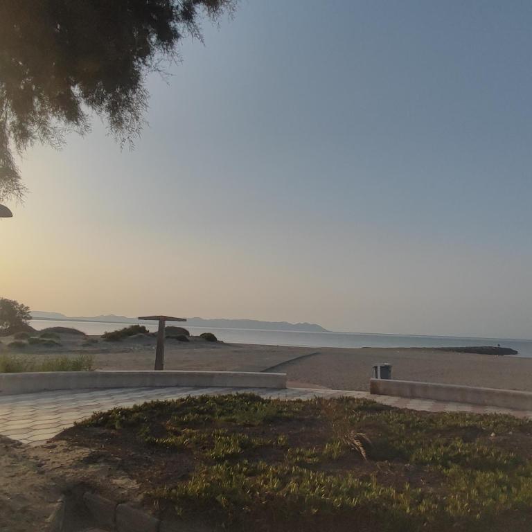 a view of the beach with an umbrella at Casa costacabana in Almería