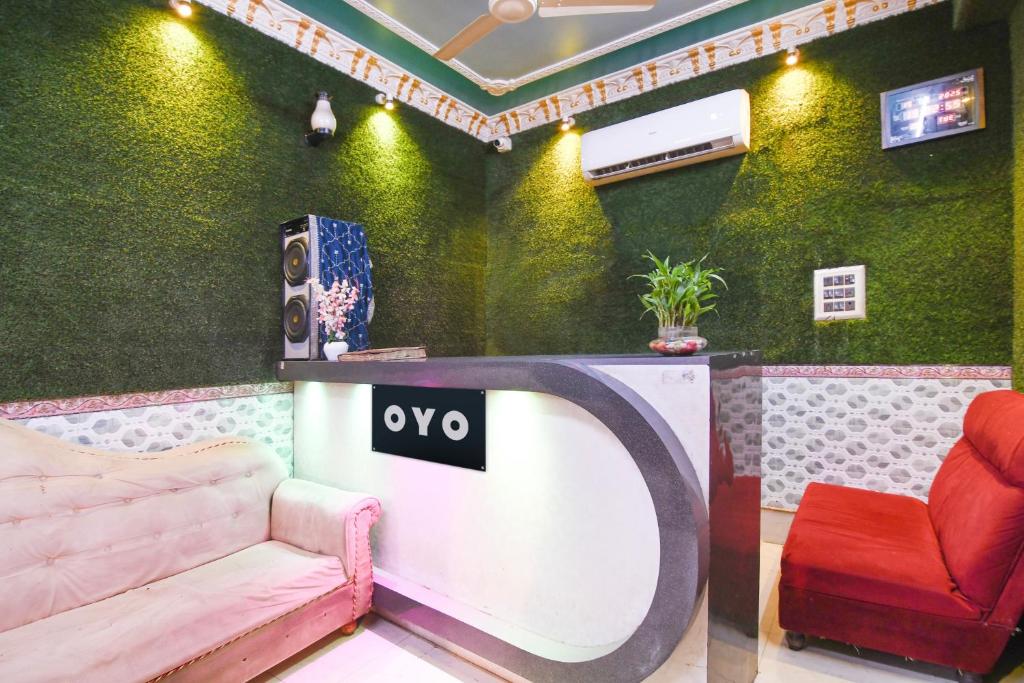 a room with a table and a couch and a speaker at Hotel O New Taj in Baharampur