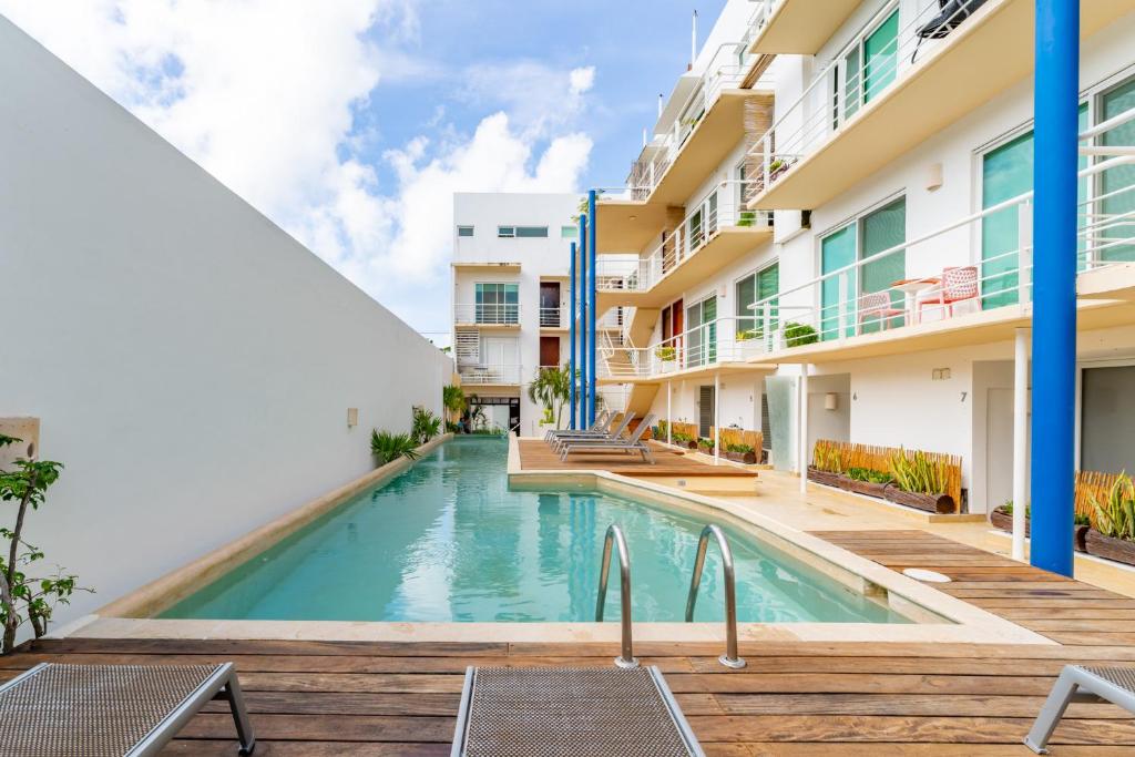 a swimming pool in front of a building at Duplex w Rooftop Plunge Pool – Walk to Beach in Playa del Carmen