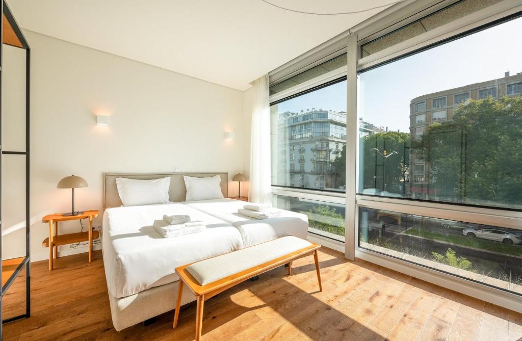 Un dormitorio con una cama y una ventana grande. en GuestReady - Republic Apartments, en Lisboa