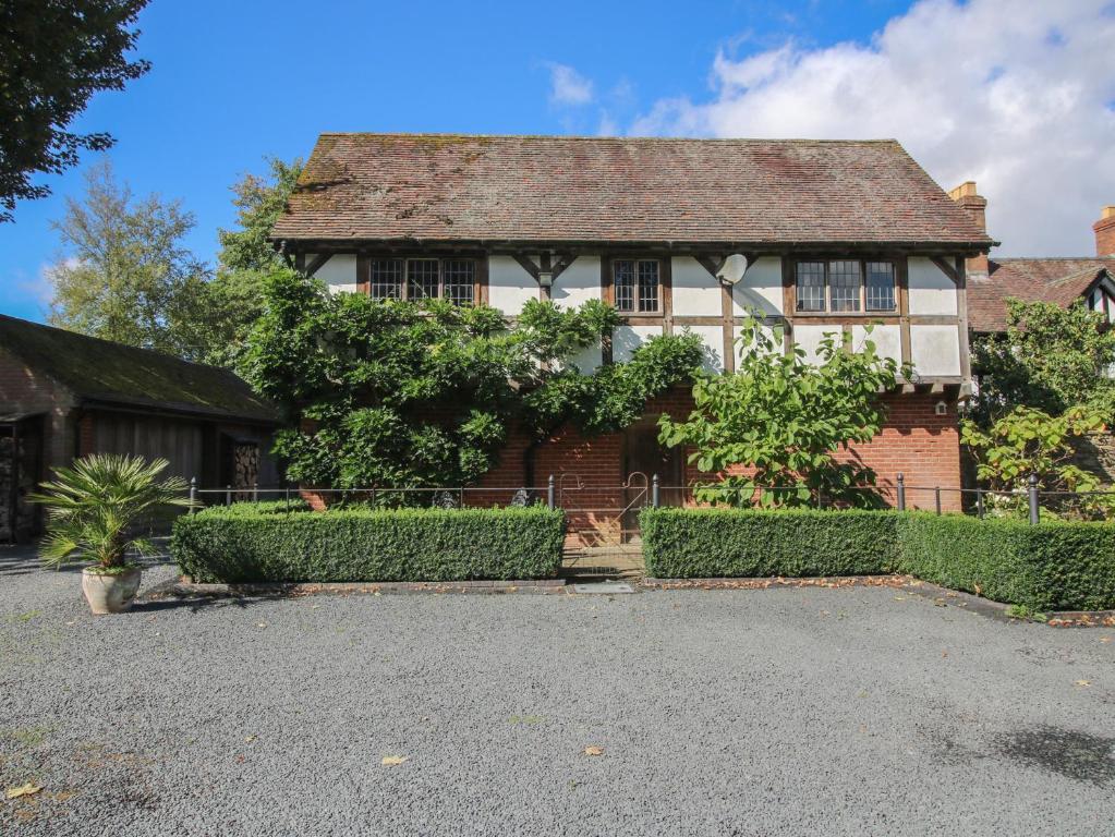 an old house with a fence in front of it at The Coach House in Church Stretton