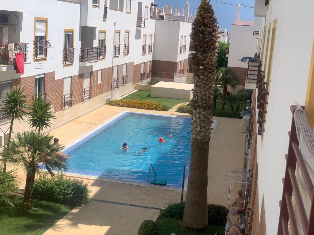 a group of people in a swimming pool in a building at Bem appartement à Cabanas de Tavira in Conceição