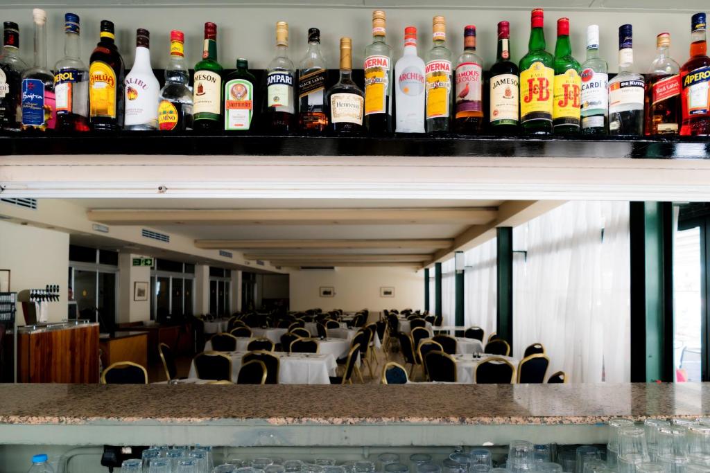 a room filled with lots of bottles of alcohol at Topaz Hotel in St Paul's Bay
