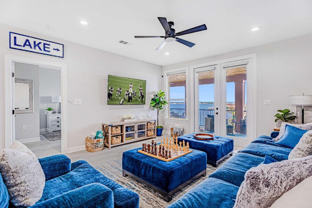 a living room with blue couches and a tv at Lakefront Horseshoe Bay Resort Shared Pool Dock in Horseshoe Bay