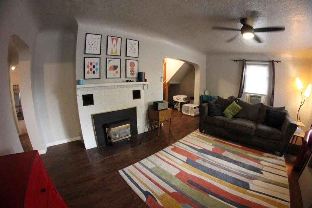 a living room with a couch and a fireplace at DOWN TOWN BUNGALOW Entire home available in Farmington