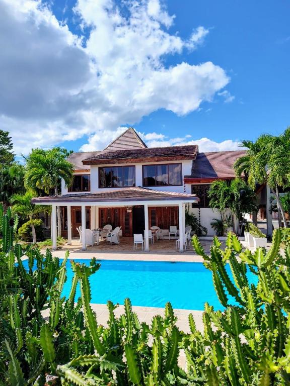 an exterior view of a house with a swimming pool at Río Mar Cumayasa in La Romana
