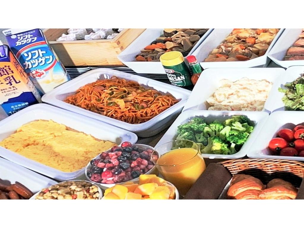 a table topped with trays of different types of food at Smile Hotel Premium Hakodate Goryokaku - Vacation STAY 97564v in Hakodate