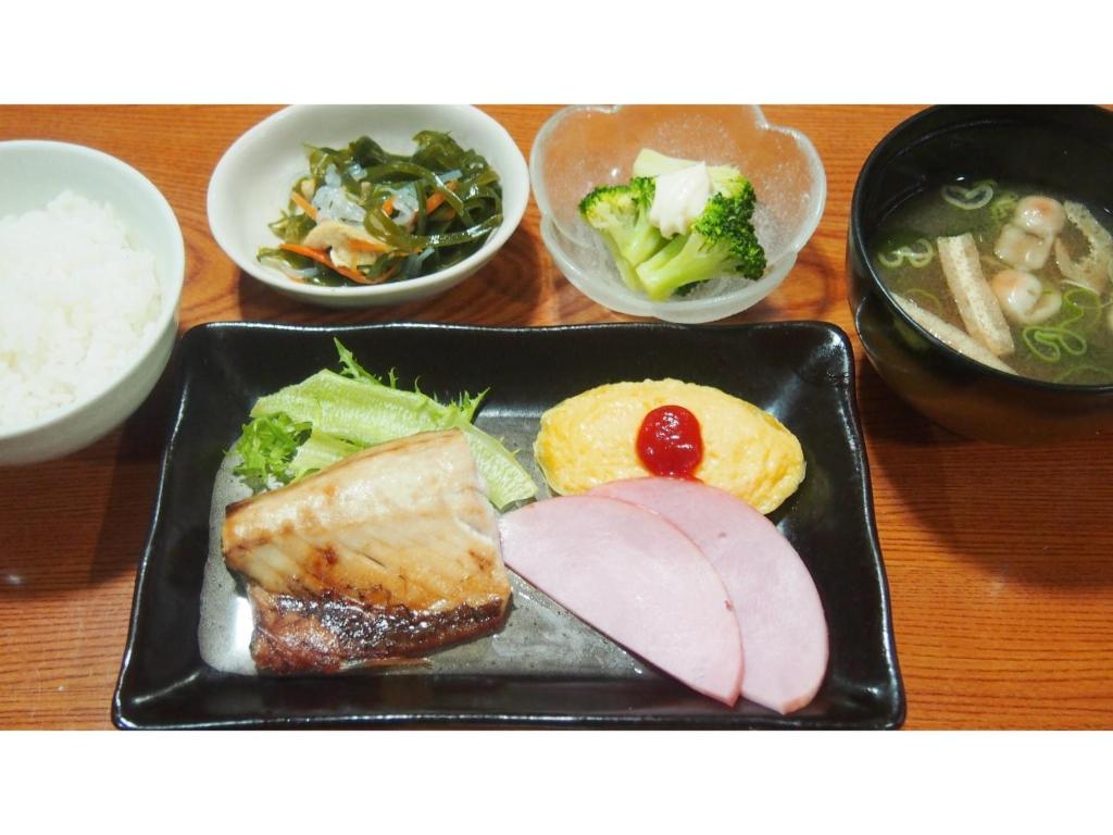 a plate of food with meat and vegetables on a table at Hotel Pacific - Vacation STAY 29737v in Ishinomaki