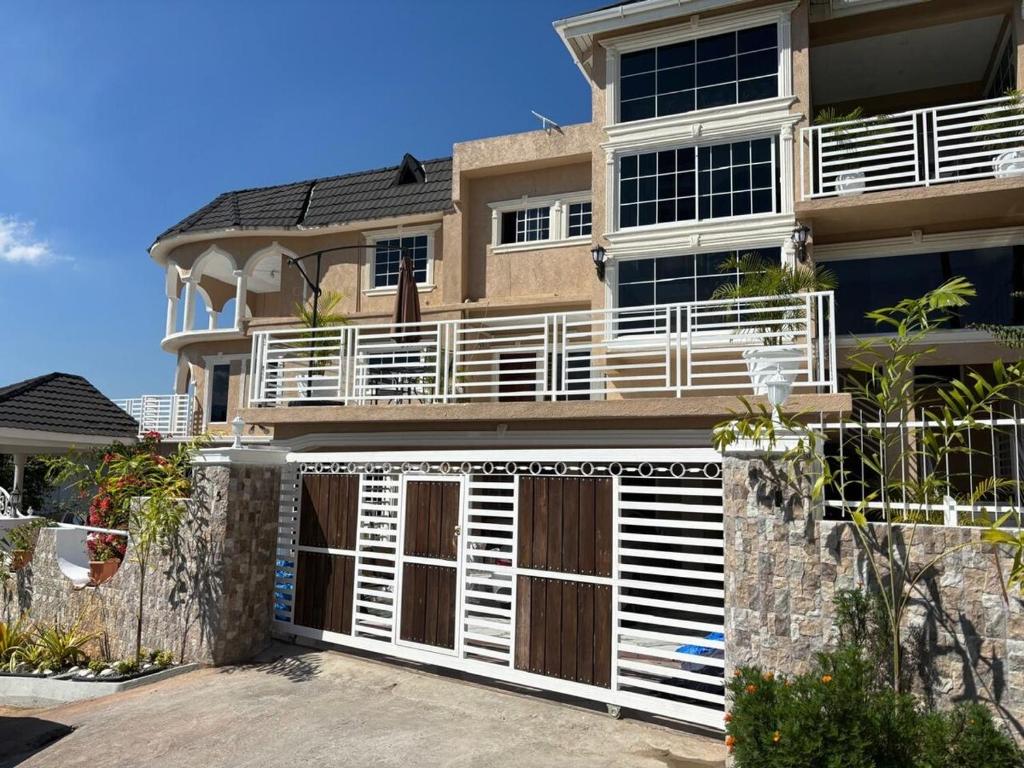 a large house with a white garage door at 360 Rokview Suites Cozy 1BR Private Suite in Kupuis