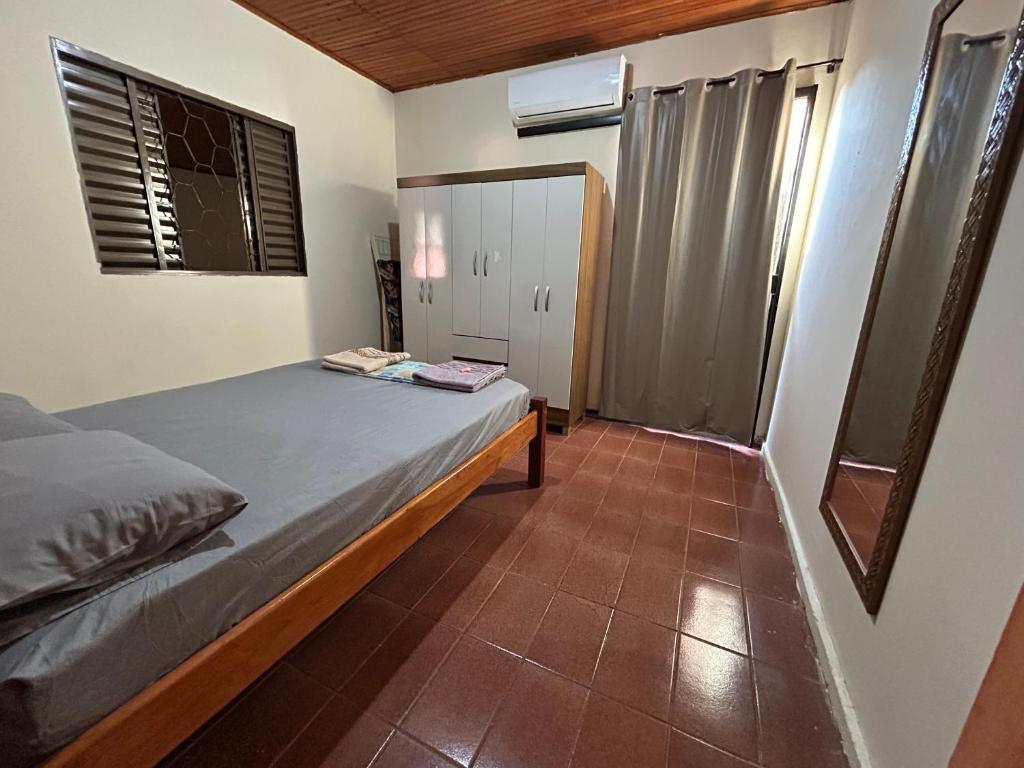 多拉杜斯Casa Parque Alvorada com garagem e ar Condicionado的一间带床和窗户的小卧室