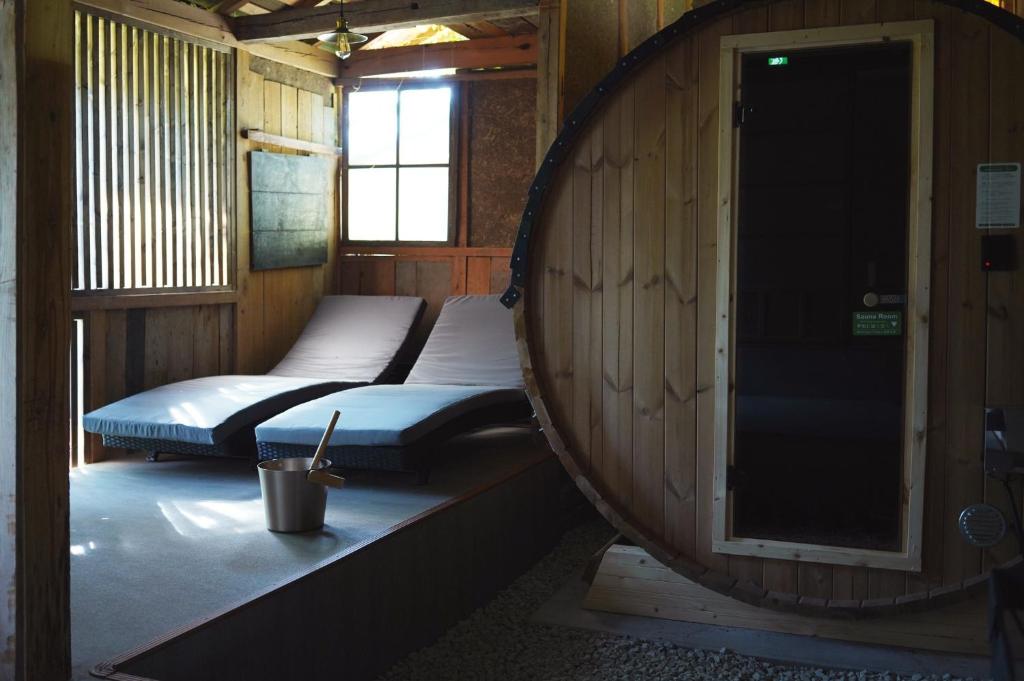two beds sitting in a room with a barrel at SAUNA&CURRY URI Kyotango - Vacation STAY 31580v in Kyotango