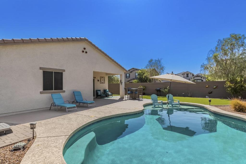 a swimming pool in the backyard of a house at Golden Marigold Sanctuary in Buckeye