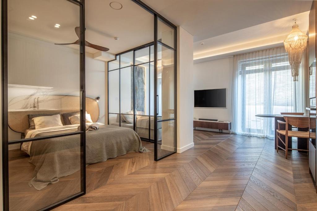 a bedroom with a bed with a glass wall at Golden Dunes & SPA in Nida