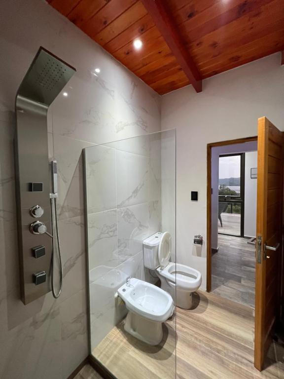 a bathroom with a toilet and a shower at EL PALMAR in Villa Carlos Paz