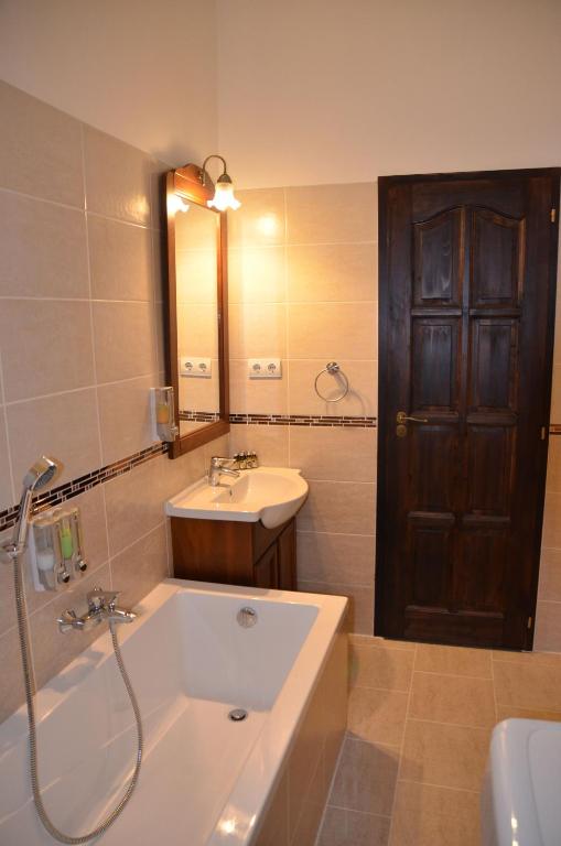 a bathroom with a bath tub and a sink at Mirage Apartments Váci Street in Budapest