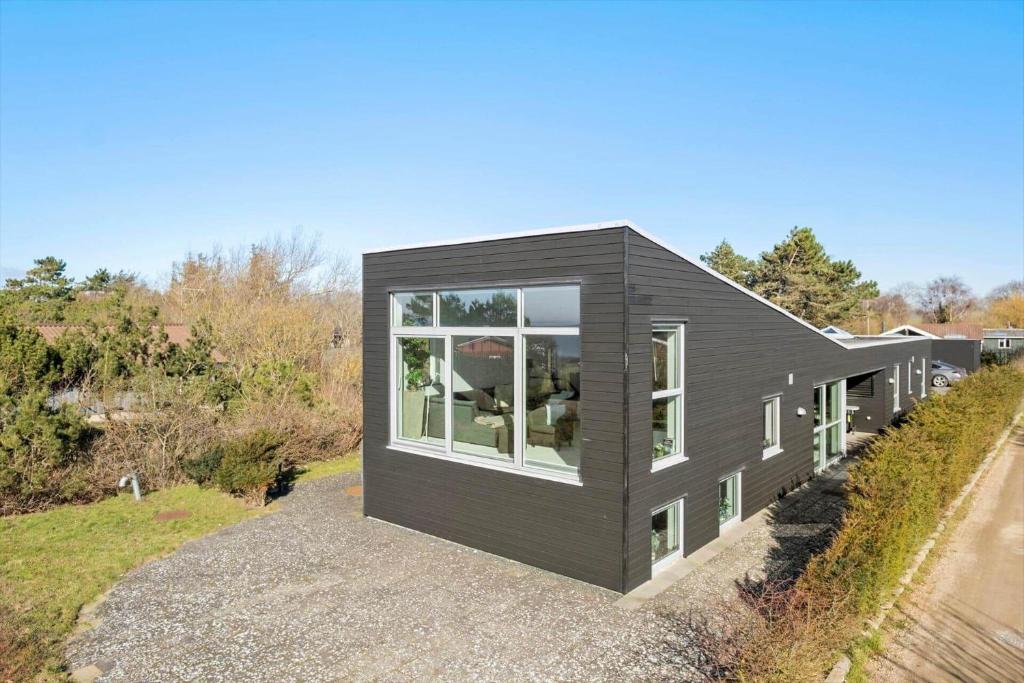 a black house with large windows on a hill at K20039-Kalundborg-Engholmen-1 in Kalundborg