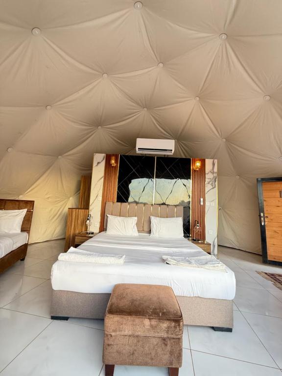 Un dormitorio con una cama grande en una tienda de campaña. en Fun Camp Wadi Rum, en Wadi Rum