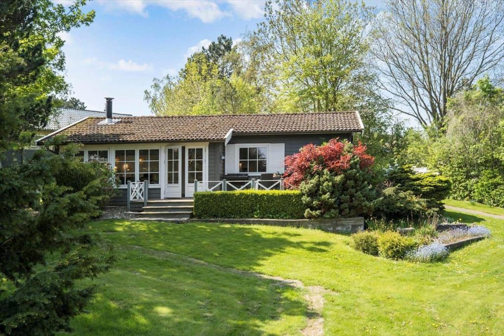 a small house with a grass yard at K19065-Kalundborg-Strandparkvej-28 in Kalundborg