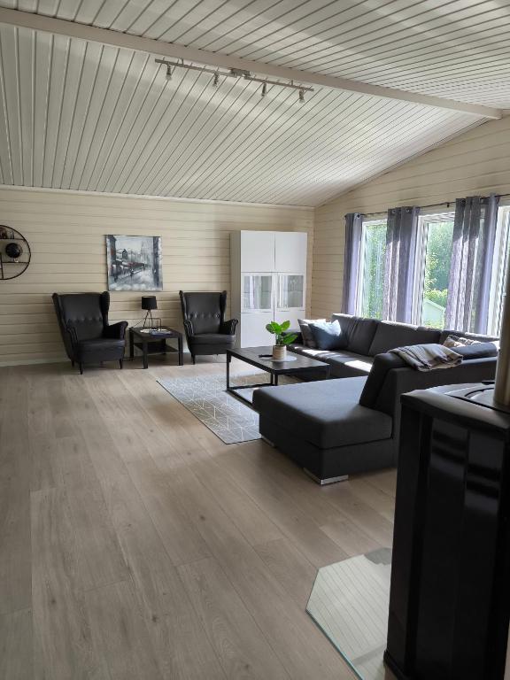 a large living room with couches and tables at Vollabakken apartment in Nordkjosbotn