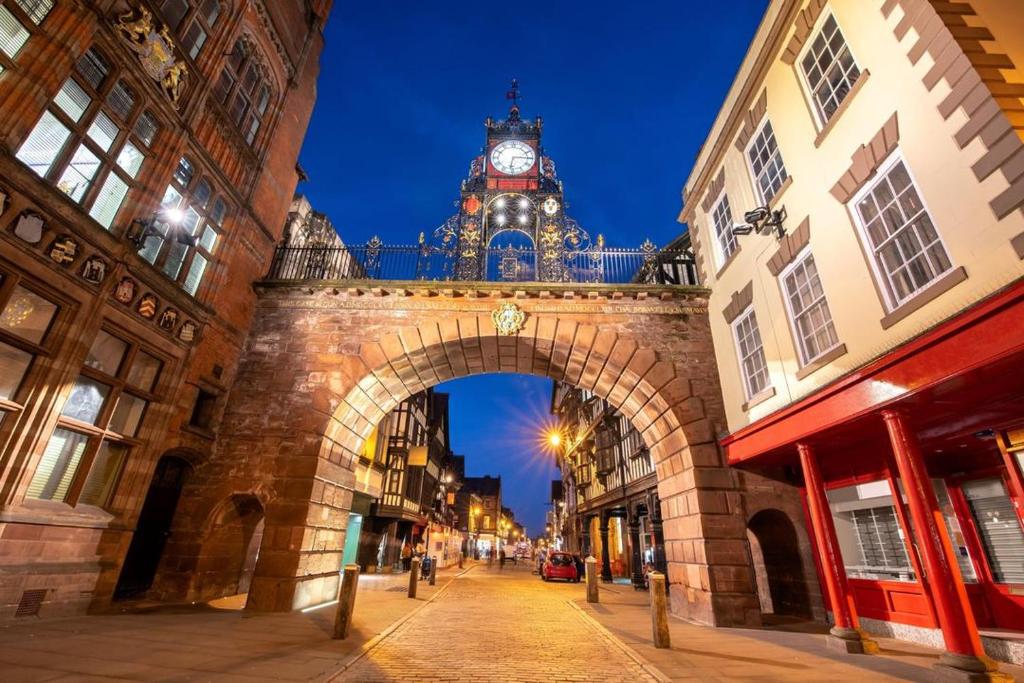 a building with a clock tower on top of it at Chester tourist apartments in Chester