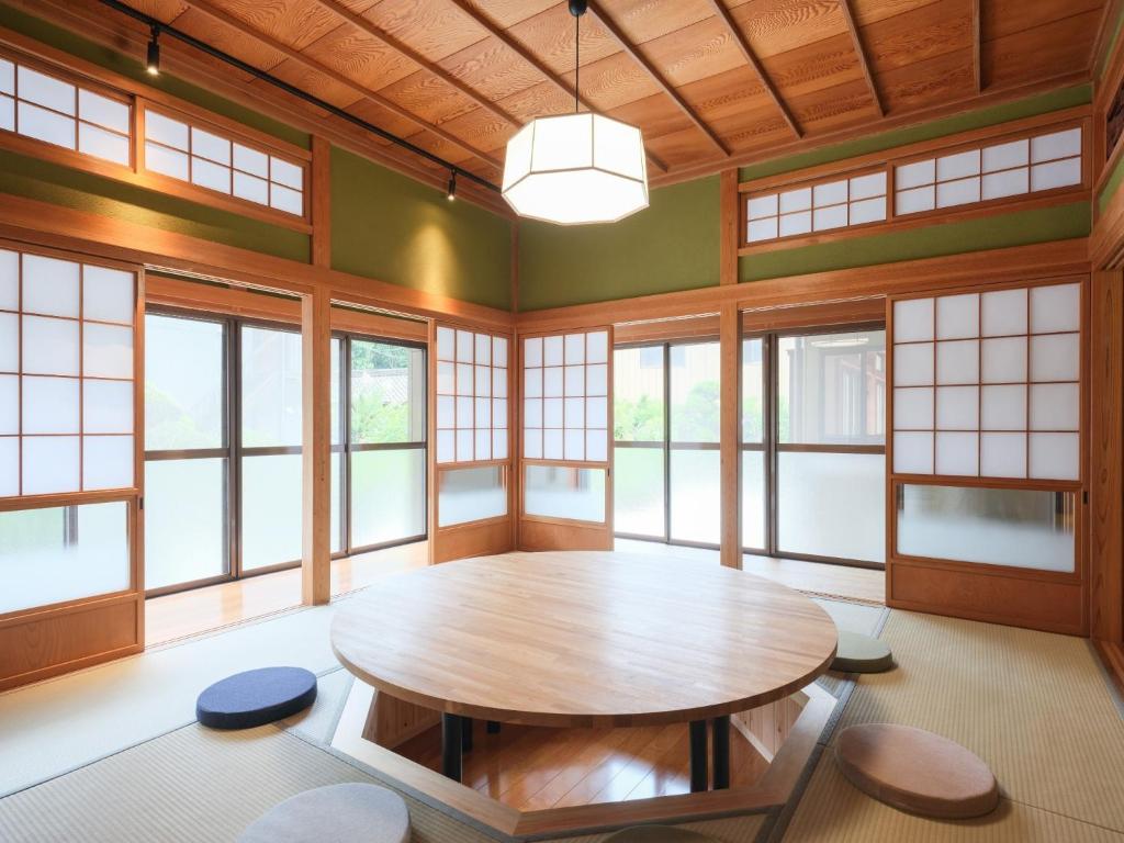 a large room with a wooden table and windows at Enza - Vacation STAY 69573v in Katori