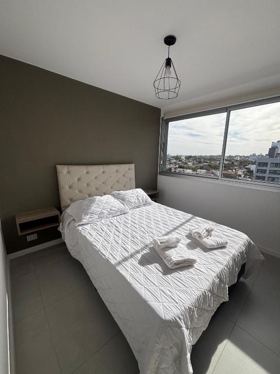 a bedroom with a bed with two slippers on it at Mirador 360 in Villa María