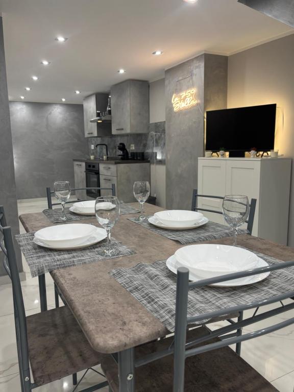 a dining room table with plates and wine glasses at La 75 Stella Home Catania in Catania