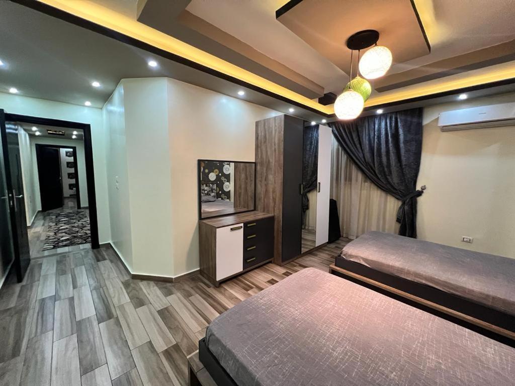 a bedroom with a bed and a television in a room at الزمالك in Cairo