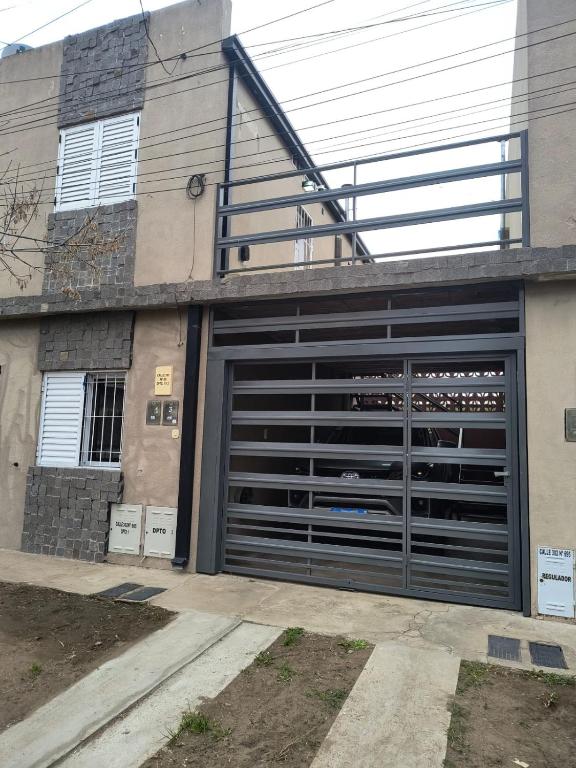 a garage door with a staircase on top of a building at DS confort dpto 3 in General Pico