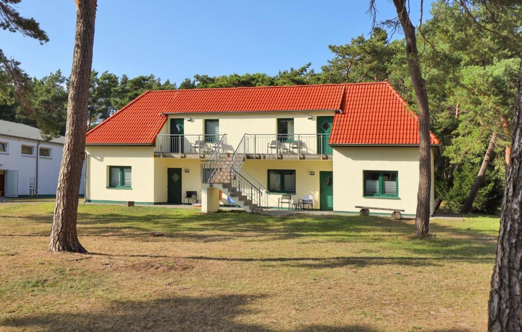a house with an orange roof and some trees at Cozy Apartment In Altenkirchen With Wifi in Altenkirchen